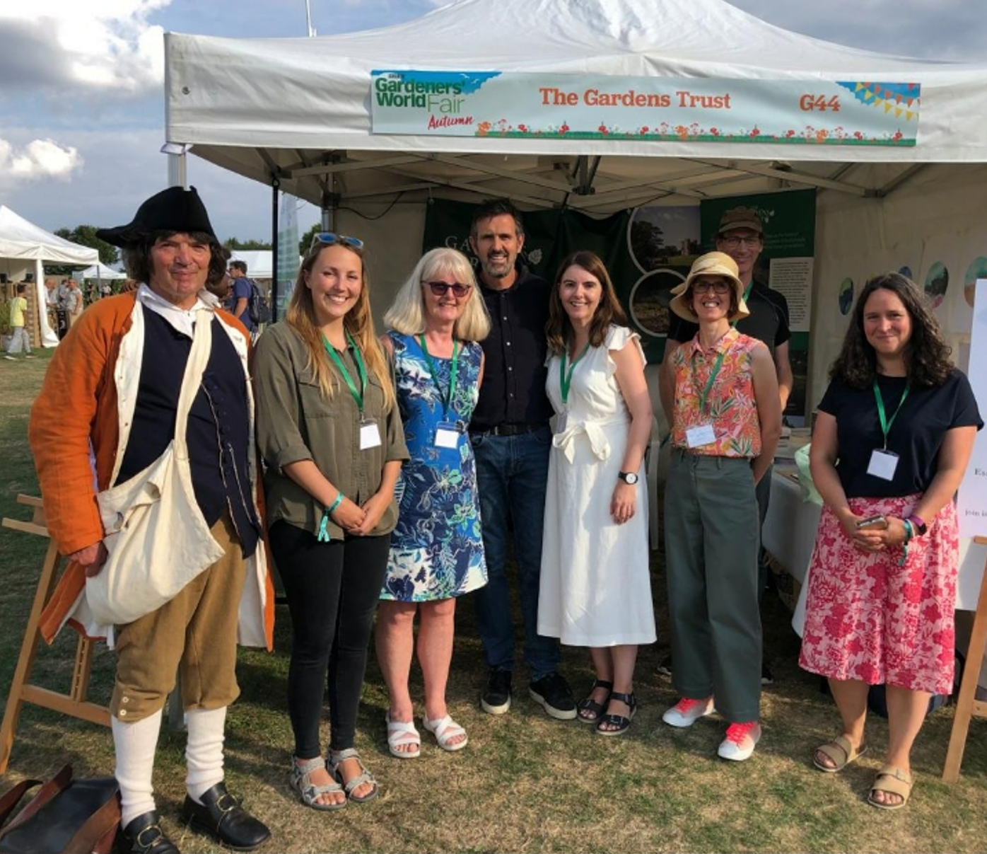 A group of Gardens Trust and Essex Gardens Trust members in front of a stall at the Gardeners World Autumn Fair, 2022. With Gardeners World presenter, Adam Frost.
