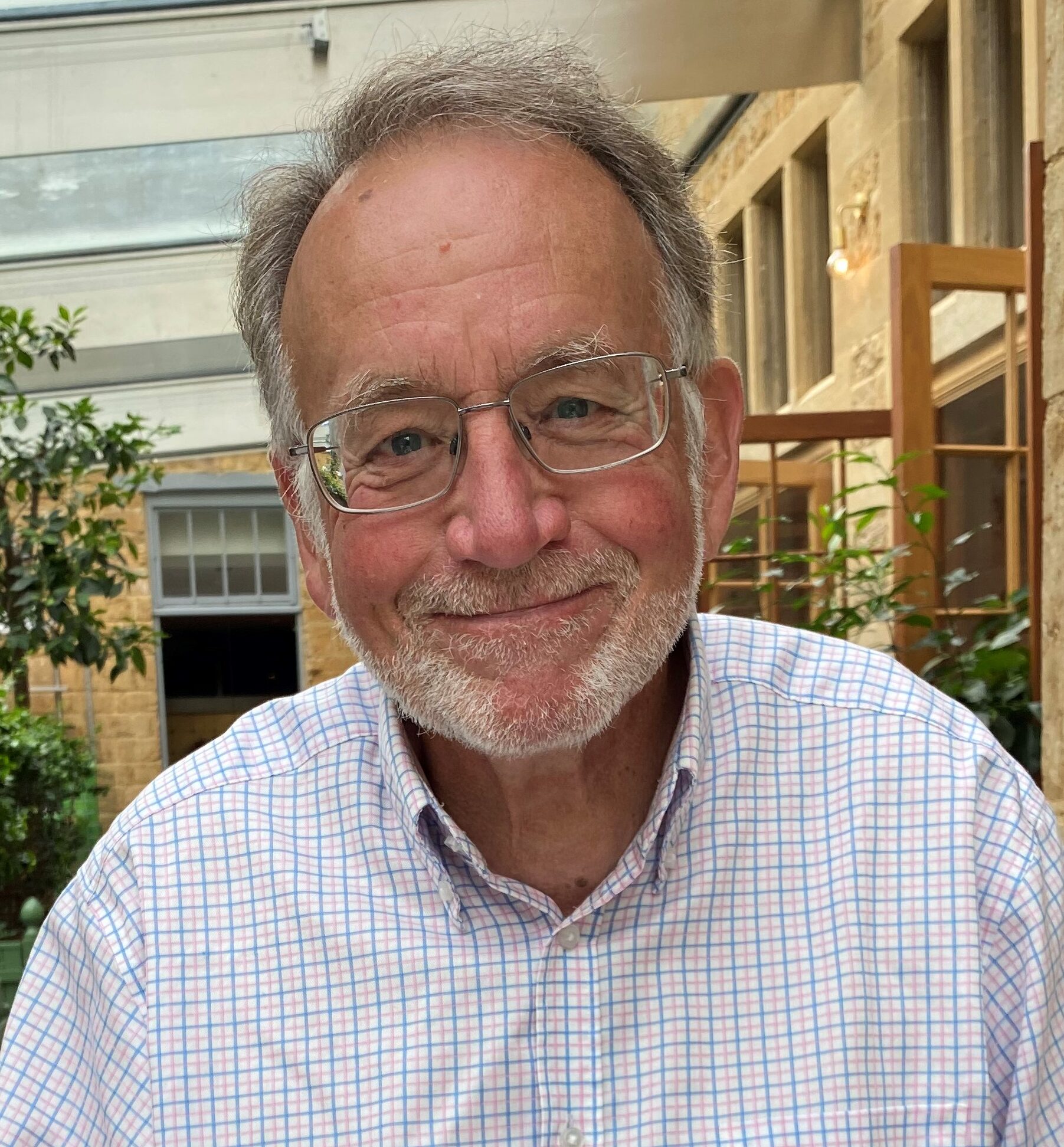 Portrait photo of Chris Blandford in a blue checked shirt.